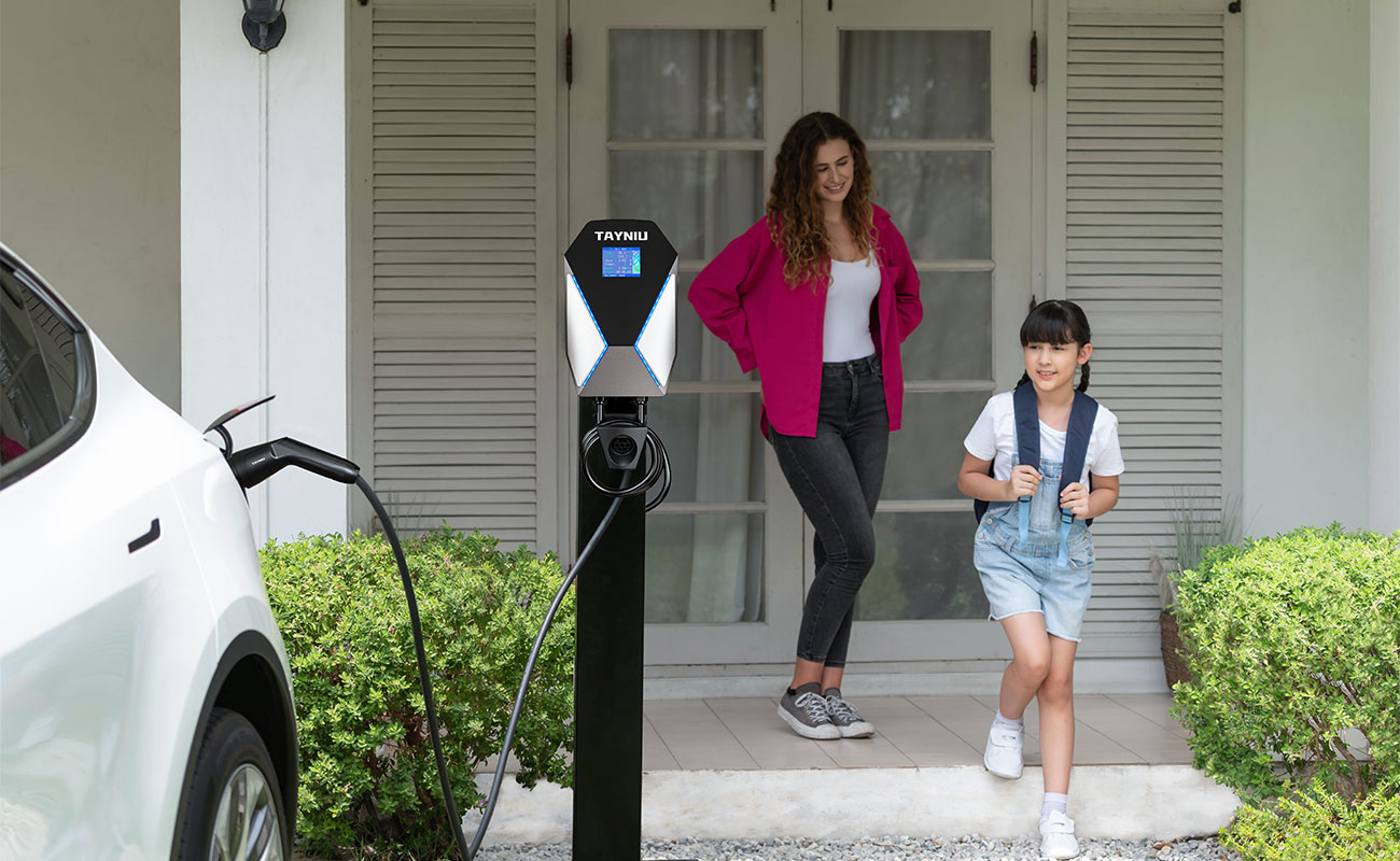 A mum is getting ready to take her daughter out of the house and the 7kw home charger is charging the car