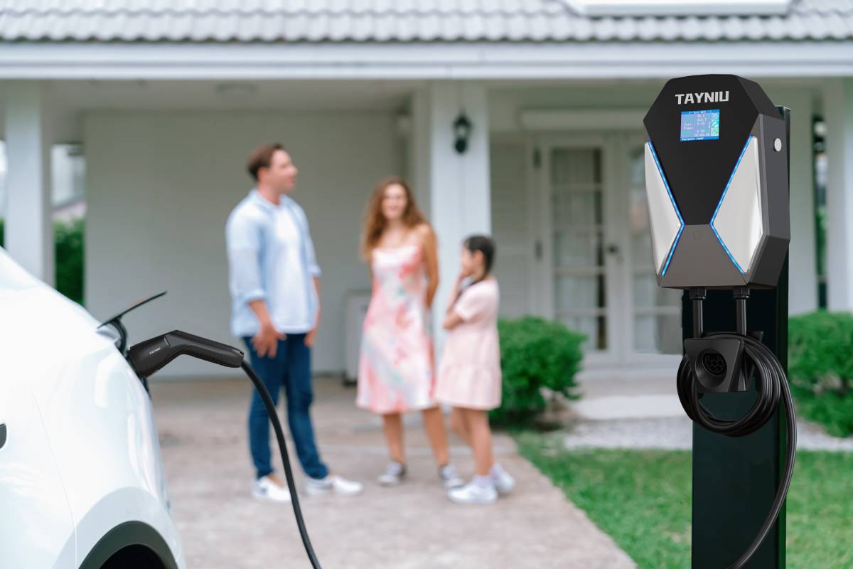 A car in the yard at home being charged using Type 2 electric vehicle charging