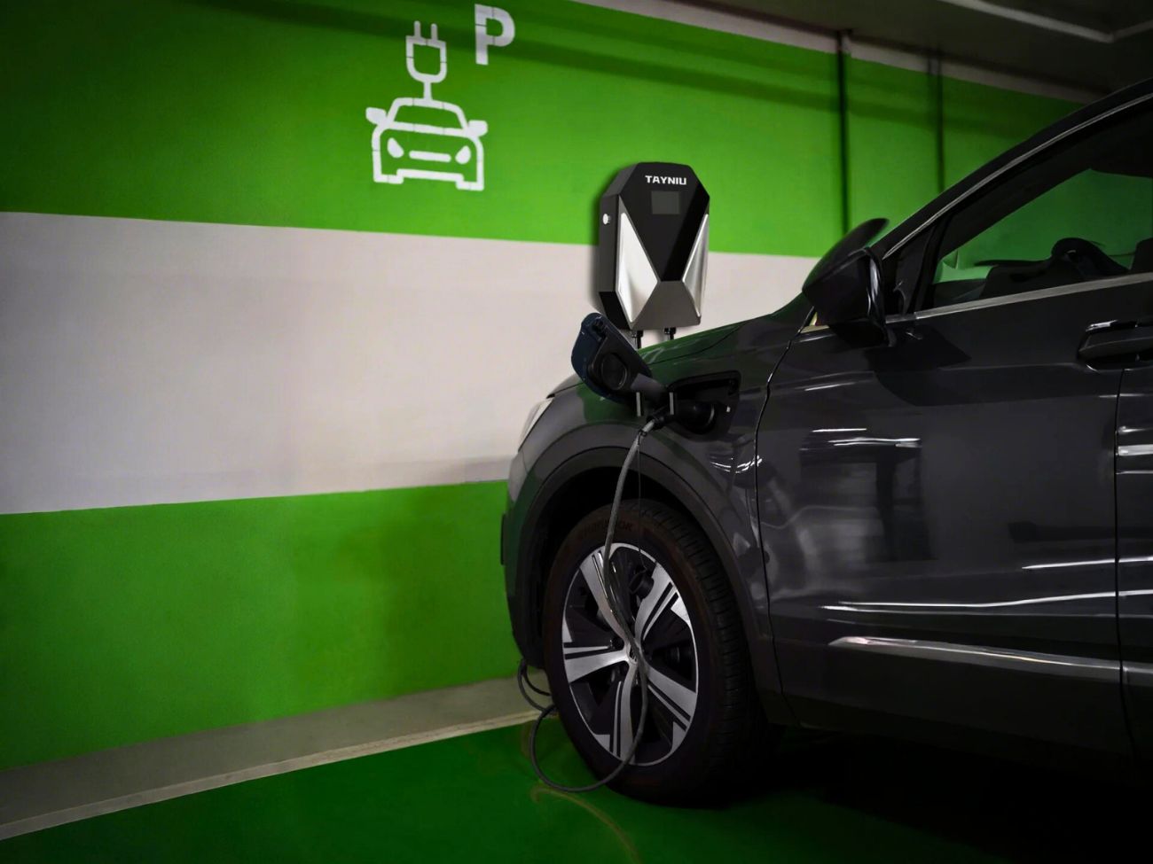 Tayniu Smart AC Charger installed in a parking garage, connected to an electric vehicle for efficient and safe charging.