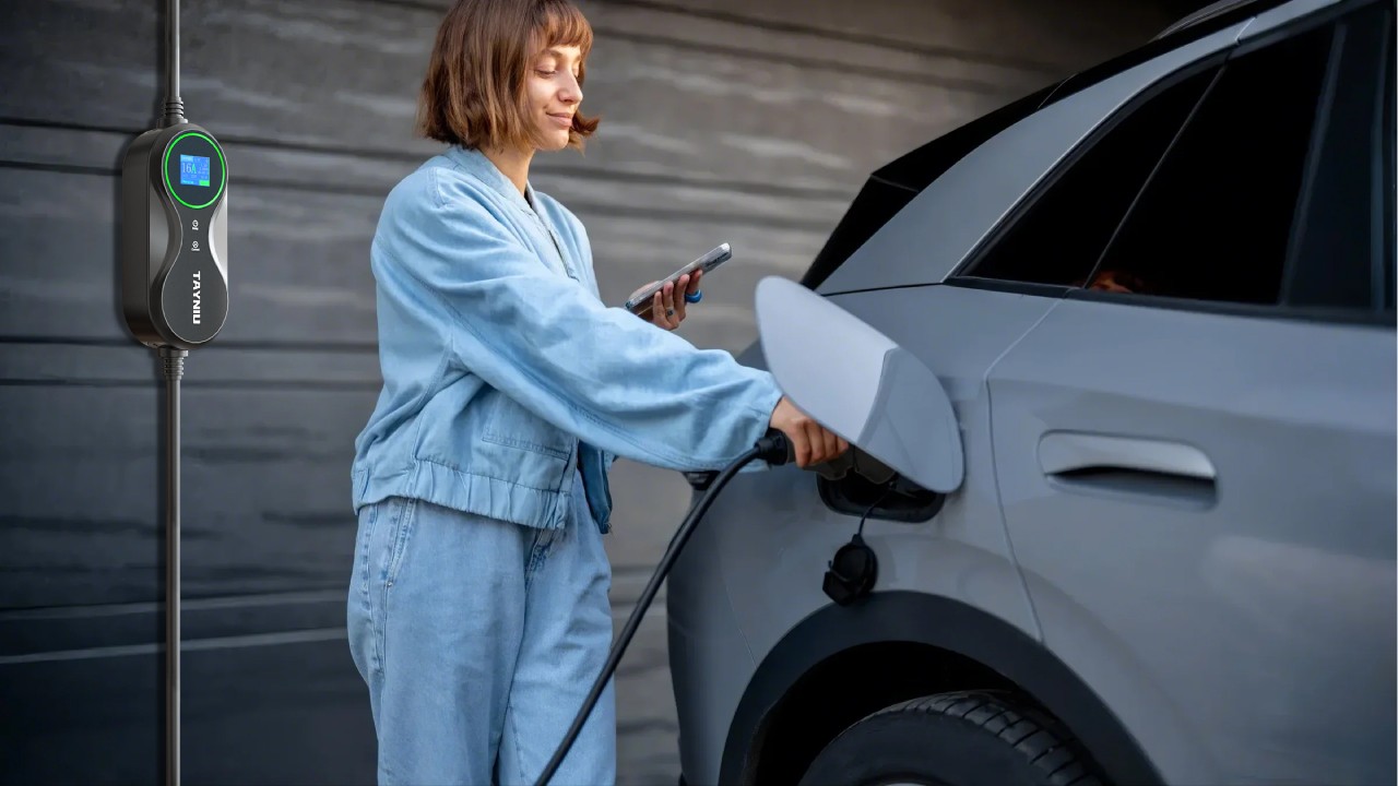 A woman charging her electric vehicle with a Tayniu portable electric car charger, showcasing a compact and user-friendly design.