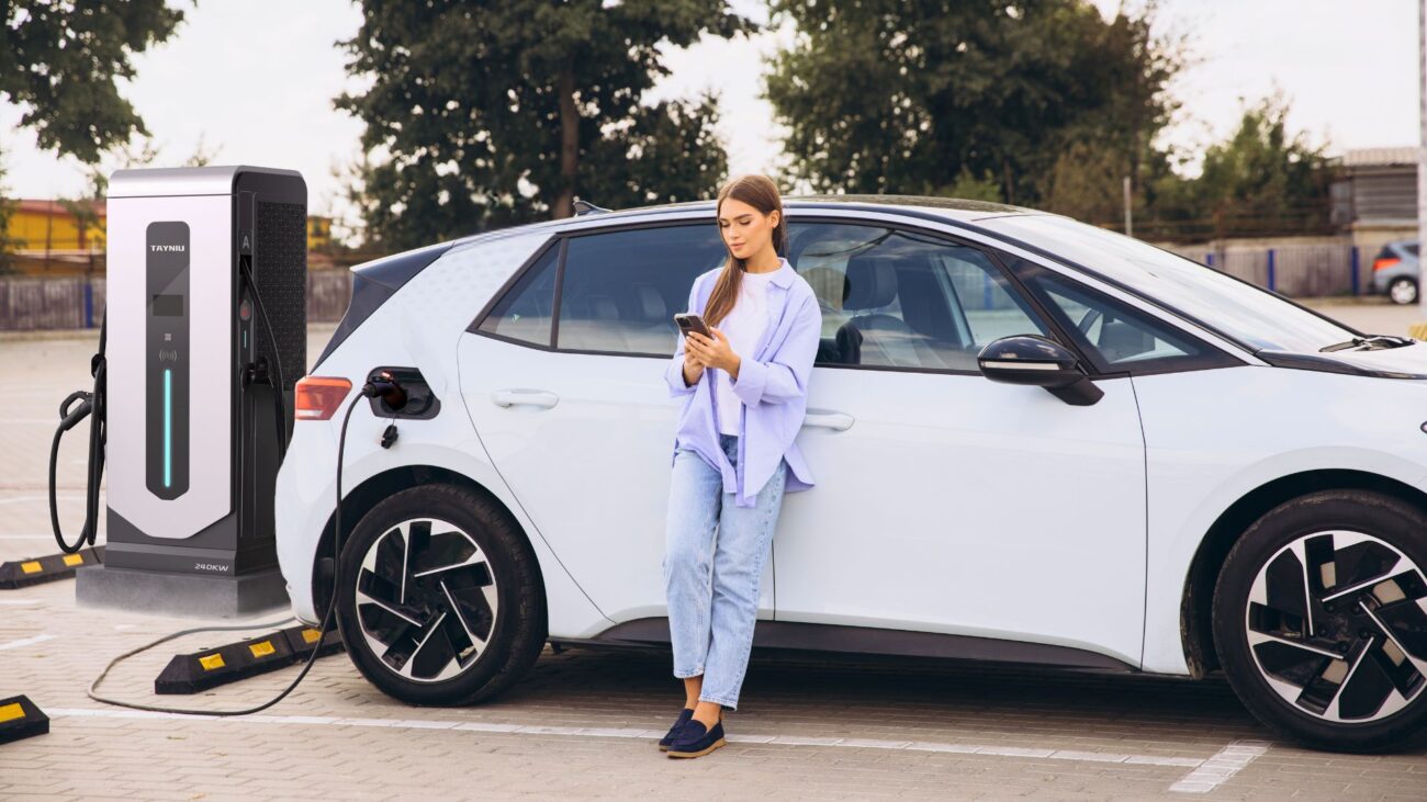 A woman charging her EV with a Tayniu Level 3 charger, reducing charging time by 80%