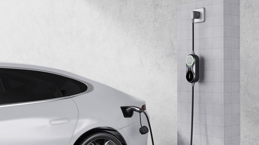 Tayniu portable EV charger plugged into a Tesla at home, offering Level 2 fast charging.